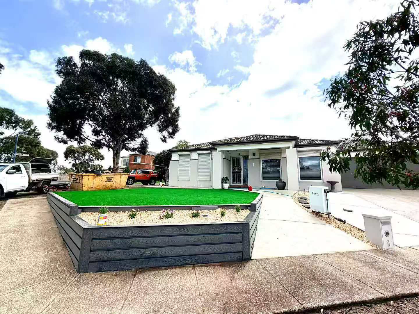 wide front view with lawn and cladding wall